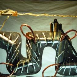 silver and copper rope on jig sawed wood with plastic tubes in branched and rope frame